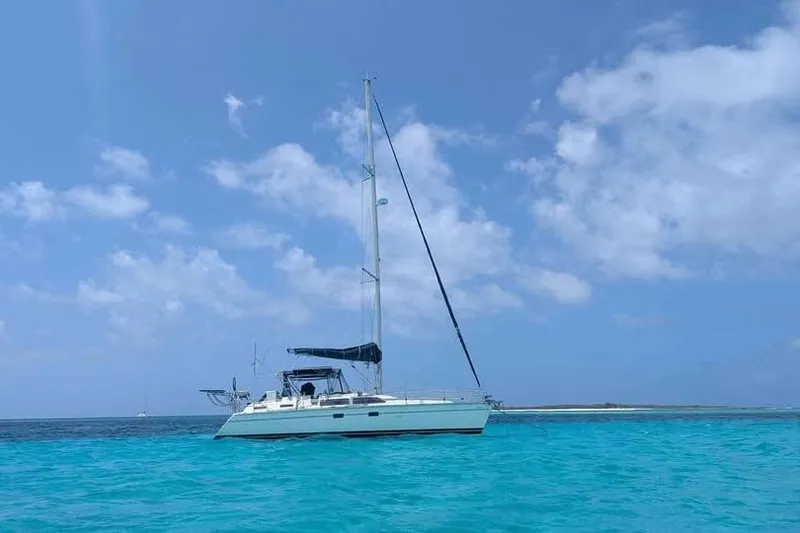 Slide: The Image of Sailboat Hunter Passage 42, 1992 model, anchored in clear turquoise waters under a blue sky. - 7
