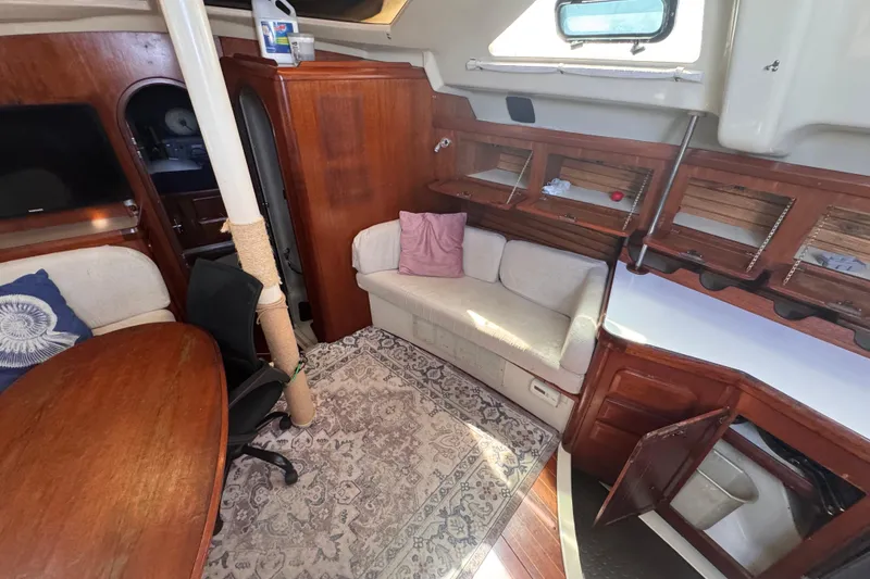 Slide: The Image of Interior of 1992 Hunter Passage 42 sailboat with cozy seating and wooden cabinetry. - 72