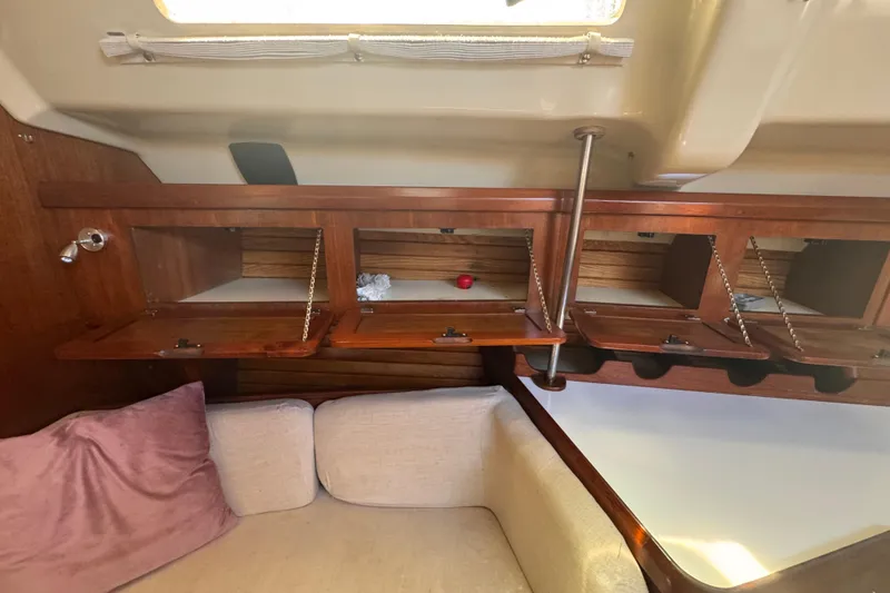 Slide: The Image of Interior of 1992 Hunter Passage 42 yacht with wooden cabinets and cozy seating area. - 74
