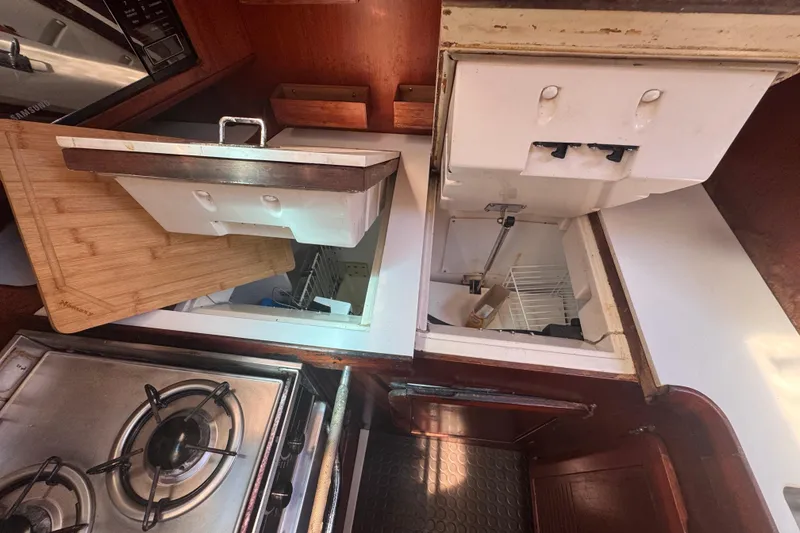 Slide: The Image of Interior of 1992 Hunter Passage 42 yacht kitchen with stove and storage compartments. - 77