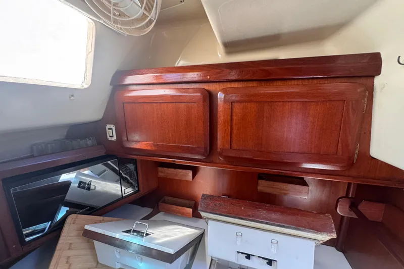 Slide: The Image of Interior of 1992 Hunter Passage 42 sailboat with wooden cabinetry and modern appliances. - 78