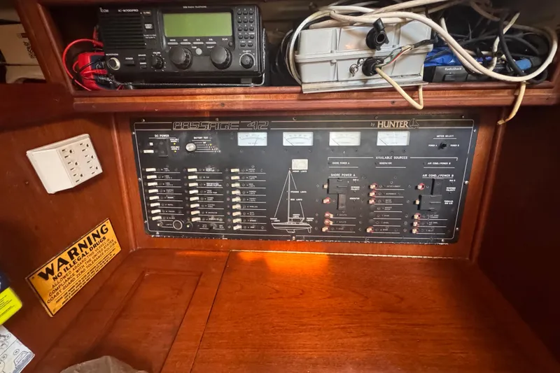 Slide: The Image of 1992 Hunter Passage 42 electrical panel with radio equipment and wiring. - 81