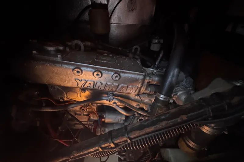 Slide: The Image of Yanmar engine inside a 1992 Hunter Passage 42 sailboat, dimly lit environment. - 89