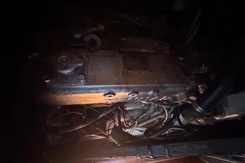 Slide: The Image of Engine compartment of a 1992 Hunter Passage 42 sailboat, showing mechanical components and wiring. - 90