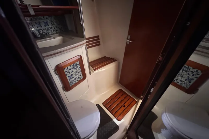 Slide: The Image of Bathroom interior of 1992 Hunter Passage 42 yacht with wooden accents and decorative tiles. - 96
