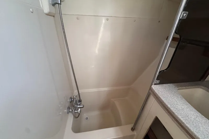 Slide: The Image of Shower area in 1992 Hunter Passage 42 yacht with handheld showerhead and compact design. - 97