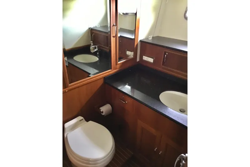 Slide: The Image of Luxurious bathroom in 2008 Grand Banks 59 Aleutian RP yacht with elegant wood cabinetry. - 17
