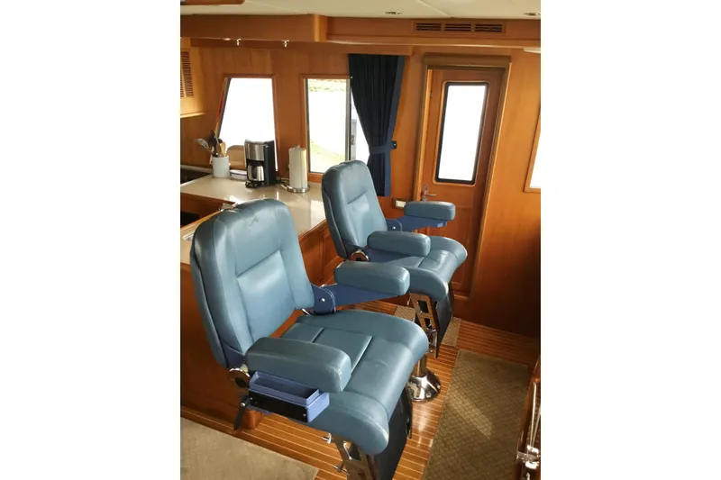 Slide: The Image of Luxurious interior of 2008 Grand Banks 59 Aleutian RP yacht with blue captain chairs. - 5