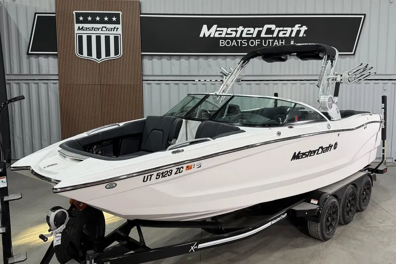The Image of 2021 MasterCraft X24 boat displayed indoors on a trailer. - 1