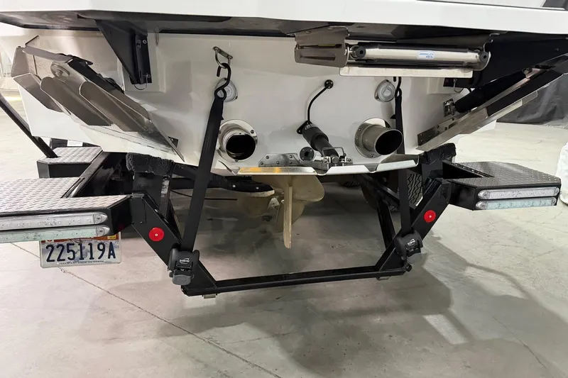 Slide: The Image of Rear view of 2021 MasterCraft X24 boat with trailer and license plate. - 16