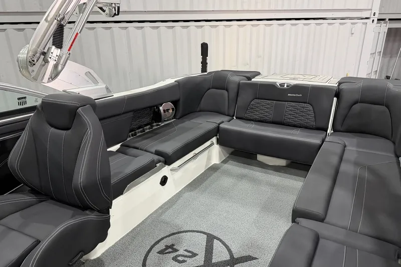Slide: The Image of 2021 MasterCraft X24 boat interior with luxurious black seating and modern design. - 5