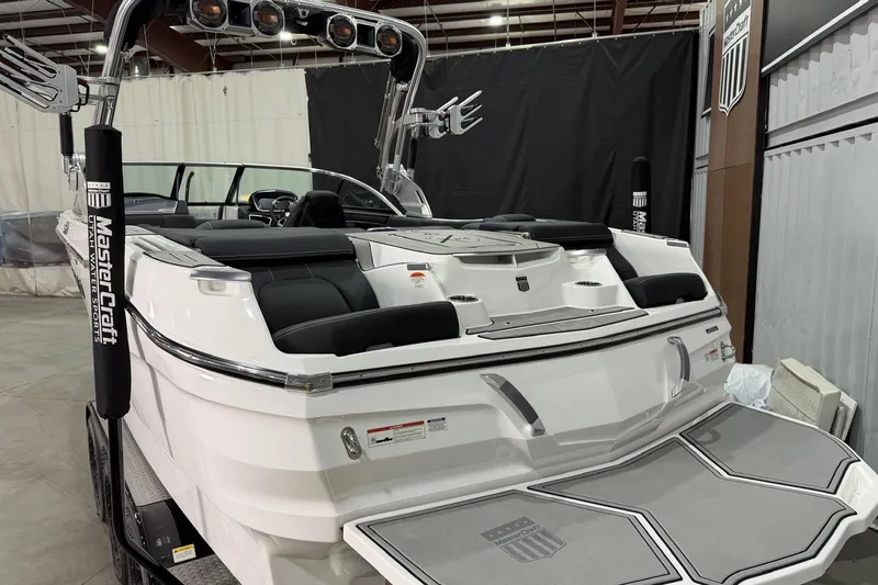 Slide: The Image of 2021 MasterCraft X24 boat with sleek design and modern features in a showroom. - 6