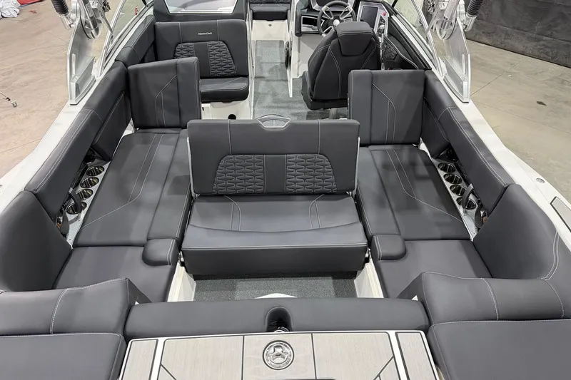 Slide: The Image of 2021 MasterCraft X24 boat interior with luxurious black seating and modern design. - 9