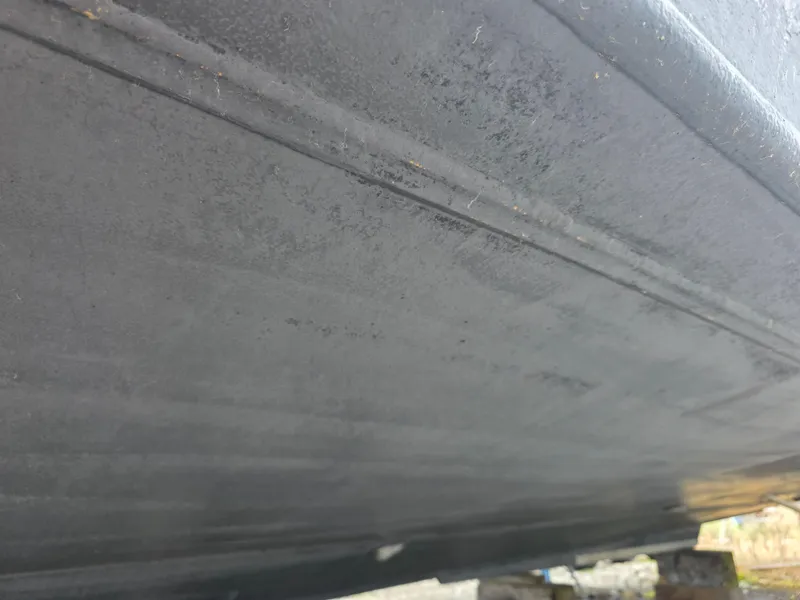 Slide: The Image of Underside of 1988 Marinette 37 Motor Yacht hull, showing texture and condition. - 11