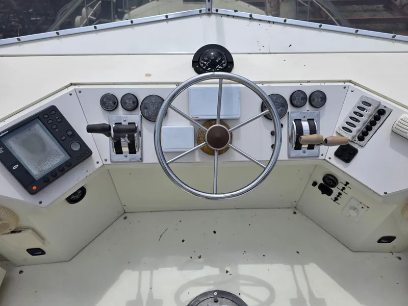 Slide: The Image of 1988 Marinette 37 Motor Yacht helm with steering wheel and control panel. - 17