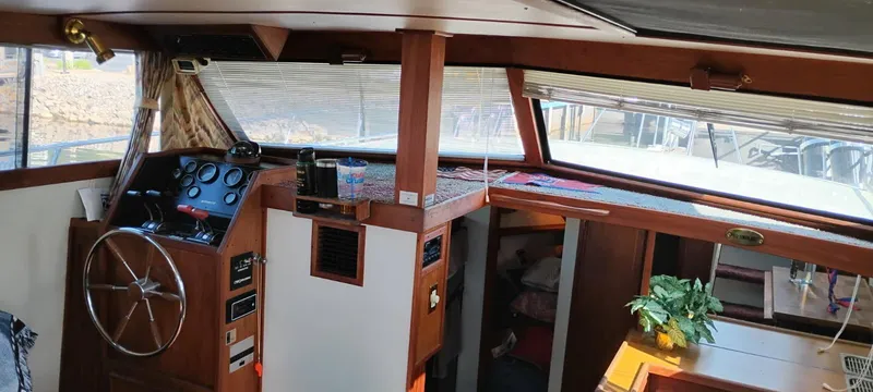 Slide: The Image of Interior of 1988 Marinette 37 Motor Yacht with helm, windows, and cozy cabin area. - 20