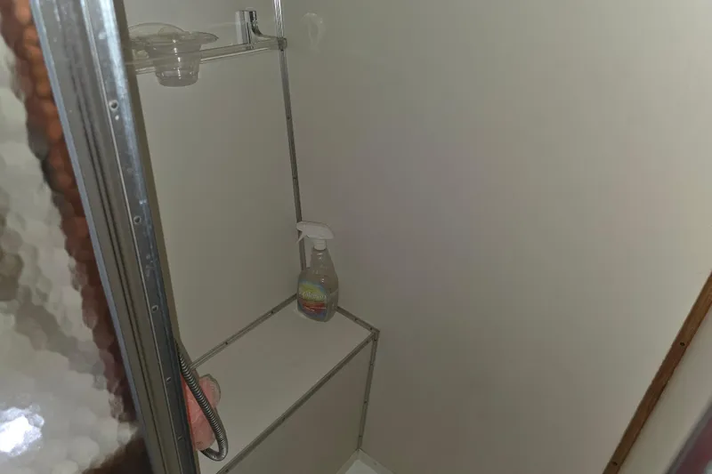 Slide: The Image of Shower area in 1988 Marinette 37 Motor Yacht with cleaning supplies. - 34
