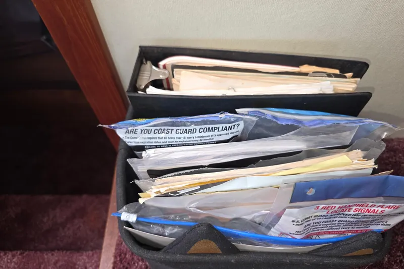 Slide: The Image of Documents and safety compliance materials on a 1988 Marinette 37 Motor Yacht. - 37