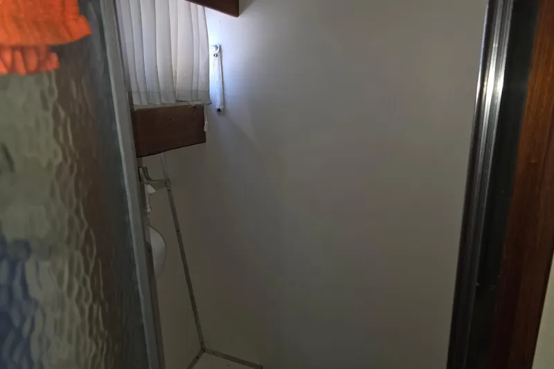 Slide: The Image of Interior of 1988 Marinette 37 Motor Yacht bathroom with shower and curtain. - 43