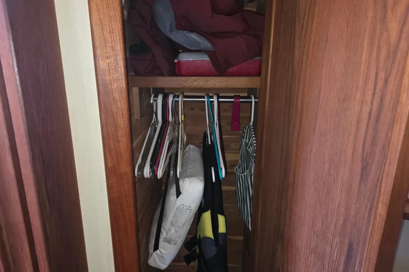 Slide: The Image of Wooden closet interior on 1988 Marinette 37 Motor Yacht with hangers and storage items. - 50