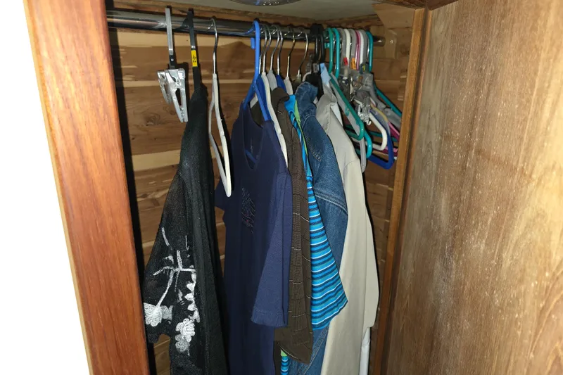 Slide: The Image of Clothes hanging in a wooden closet on a 1988 Marinette 37 Motor Yacht. - 51