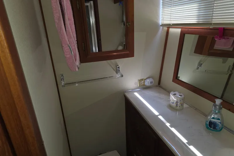 Slide: The Image of Bathroom interior of 1988 Marinette 37 Motor Yacht with mirror, towel, and toiletries. - 56