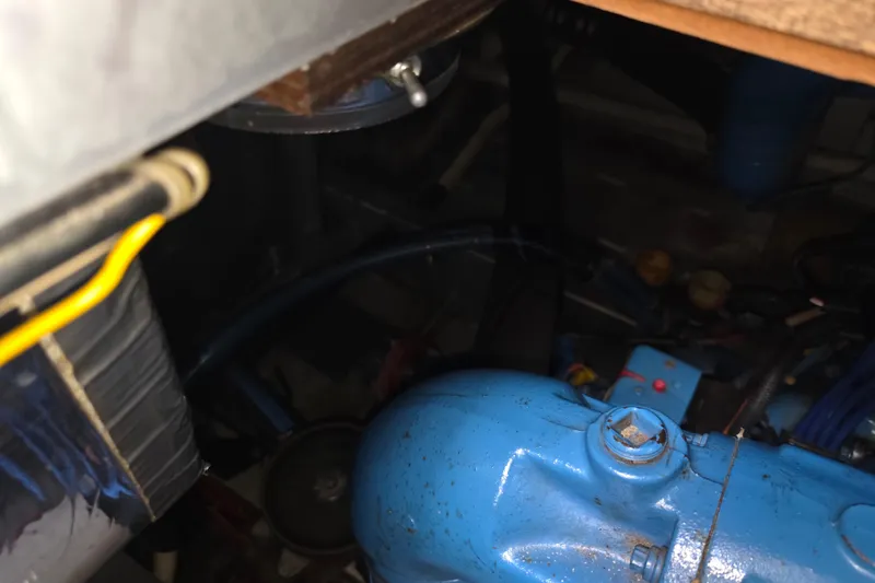 Slide: The Image of Engine compartment of a 1988 Marinette 37 Motor Yacht, featuring blue engine components. - 61