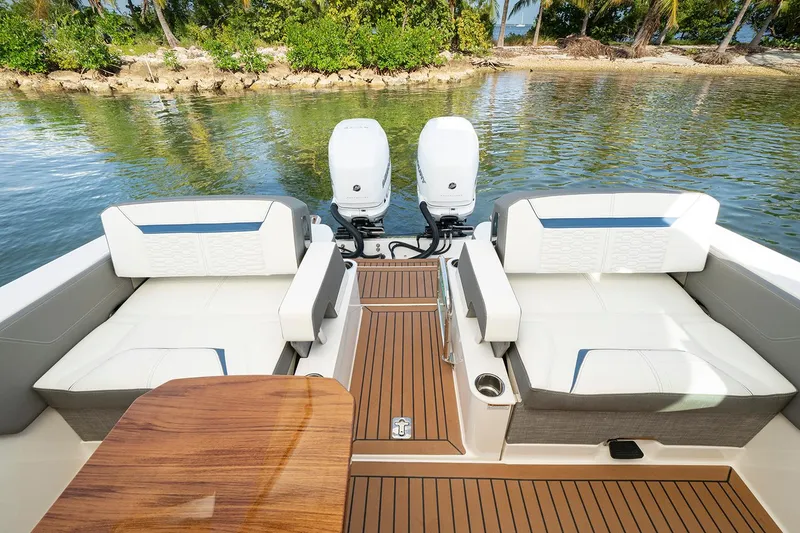 Slide: The Image of Manufacturer Provided Image: 2025 Tiara Yachts 34 LX interior with seating, table, and dual outboard motors. - 9