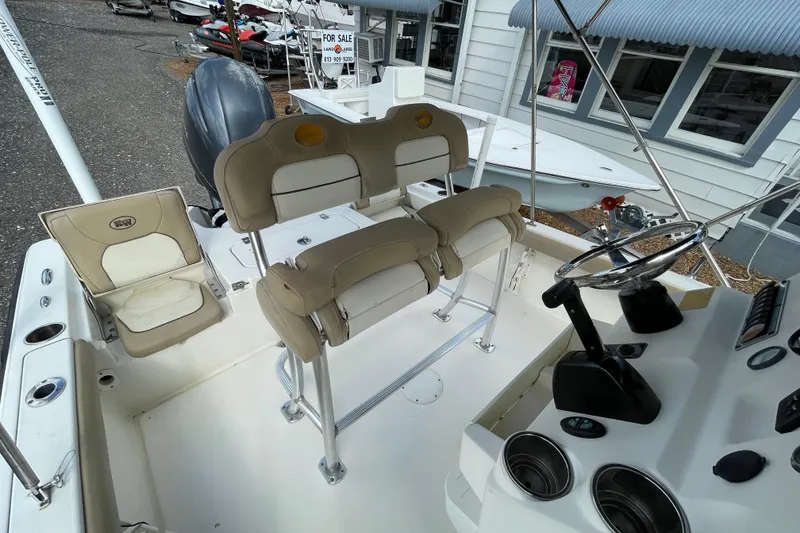 Slide: The Image of 2014 Key West 210 Bay Reef boat interior with seating and steering console. - 10