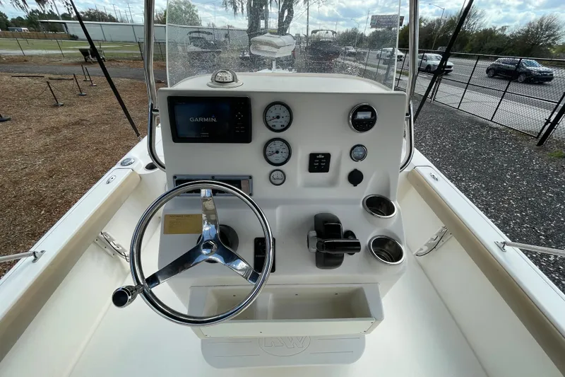 Slide: The Image of 2014 Key West 210 Bay Reef boat dashboard with Garmin navigation system and steering wheel. - 11