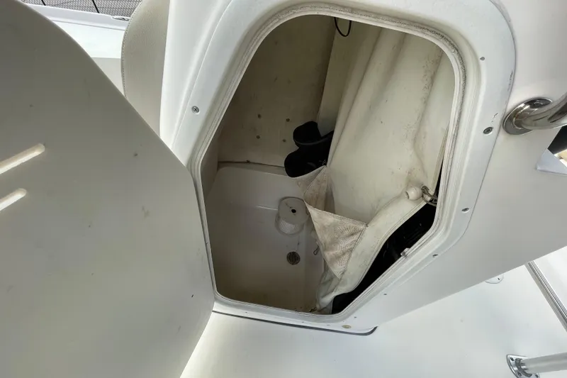 Slide: The Image of 2014 Key West 210 Bay Reef boat storage compartment with open door. - 18