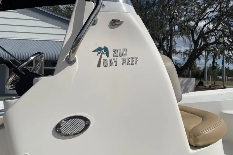 Slide: The Image of 2014 Key West 210 Bay Reef boat console with logo and seating. - 2