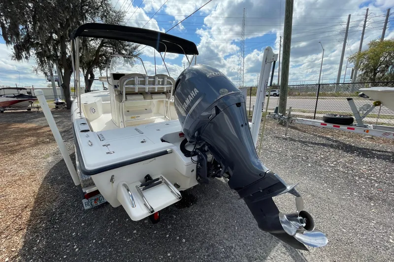 Slide: The Image of 2014 Key West 210 Bay Reef boat with Yamaha outboard motor, parked outdoors. - 4