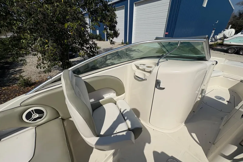 Slide: The Image of Interior of a 2011 Sea Ray 185 Sport boat with seating and cup holders. - 14