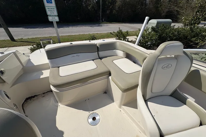 Slide: The Image of 2011 Sea Ray 185 Sport boat interior with cushioned seating and steering chair. - 15