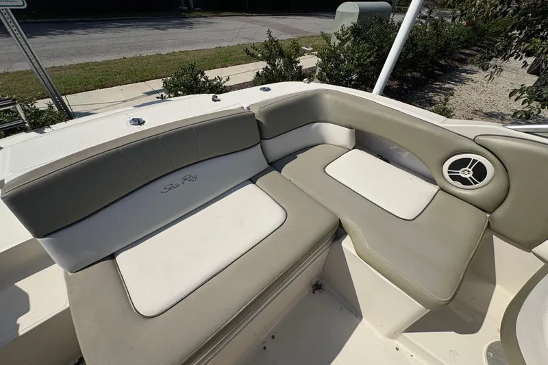 Slide: The Image of 2011 Sea Ray 185 Sport boat interior with cushioned seating and speaker. - 16
