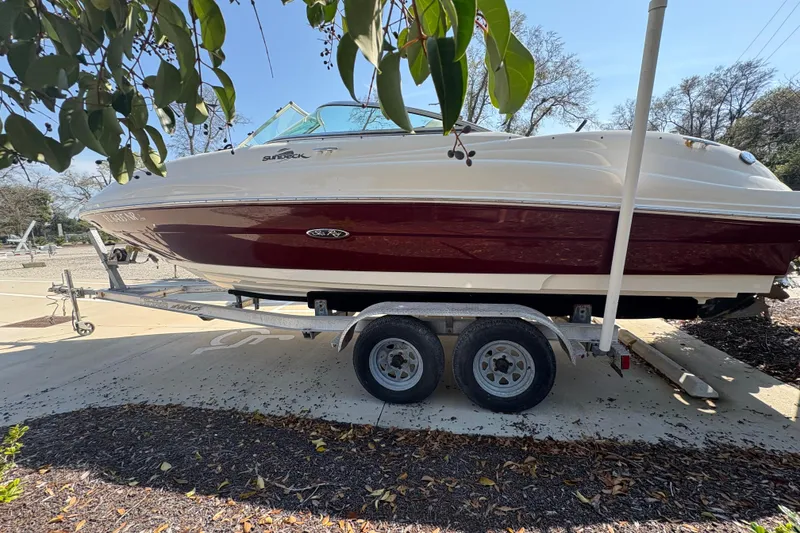 Slide: The Image of 2011 Sea Ray 185 Sport boat on trailer, parked outdoors. - 4