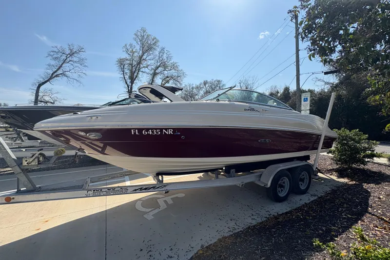 Slide: The Image of 2011 Sea Ray 185 Sport boat on trailer, parked outdoors under clear sky. - 5