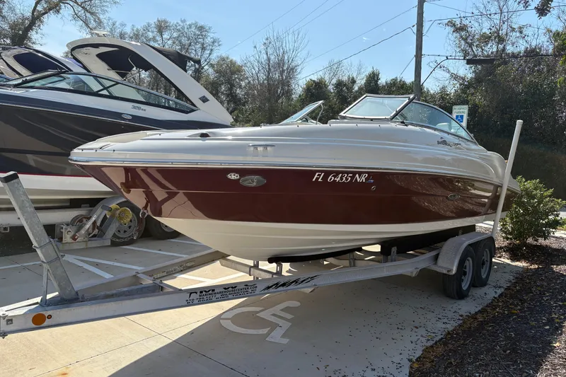 Slide: The Image of 2011 Sea Ray 185 Sport boat on trailer, parked outdoors in sunny setting. - 6