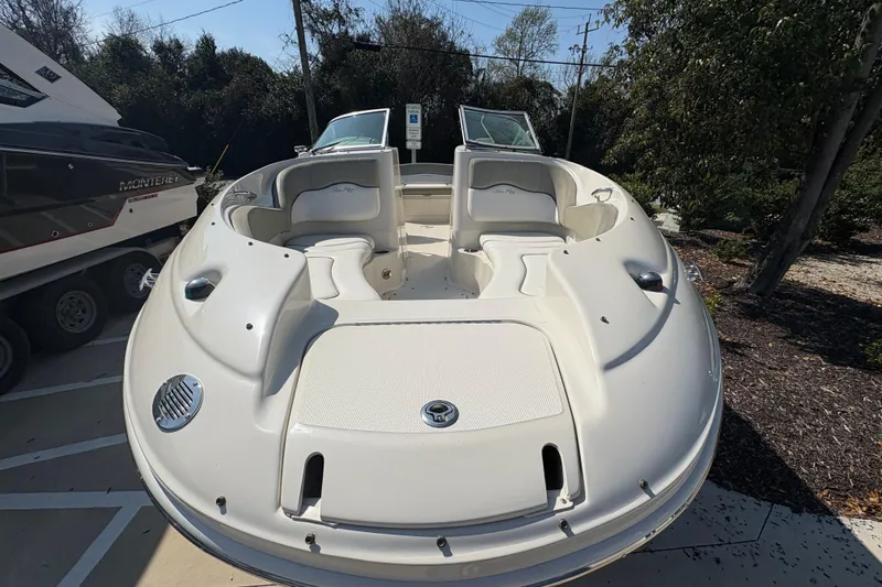 Slide: The Image of 2011 Sea Ray 185 Sport boat with open bow seating, parked outdoors. - 7