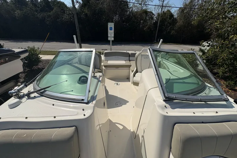 Slide: The Image of 2011 Sea Ray 185 Sport boat with open cockpit and seating, parked outdoors. - 9