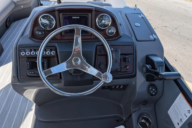 Slide: The Image of 2022 South Bay 525 RS boat dashboard with steering wheel and control panel. - 10
