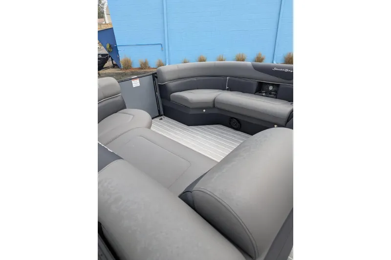 Slide: The Image of 2022 South Bay 525 RS pontoon boat interior with gray seating and sleek design. - 13