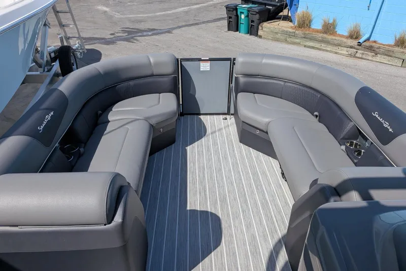 Slide: The Image of 2022 South Bay 525 RS boat interior with gray seating and striped flooring. - 15