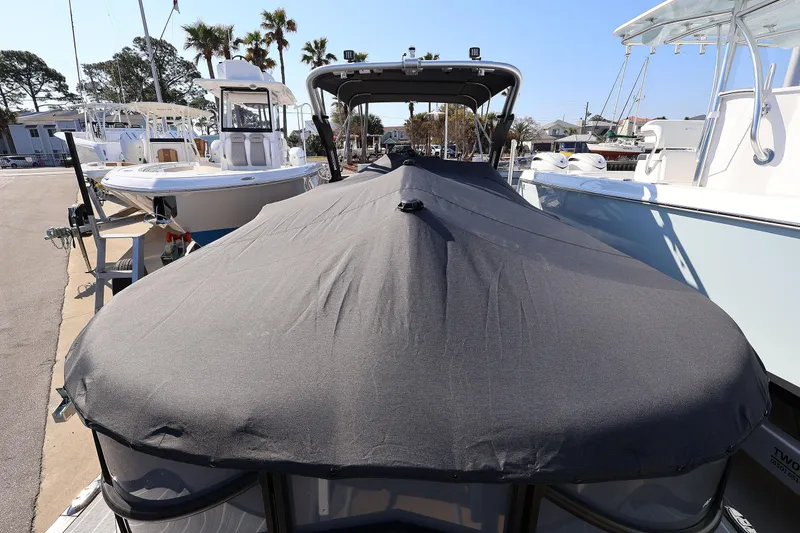 Slide: The Image of 2022 South Bay 525 RS boat covered at marina, surrounded by other boats. - 19