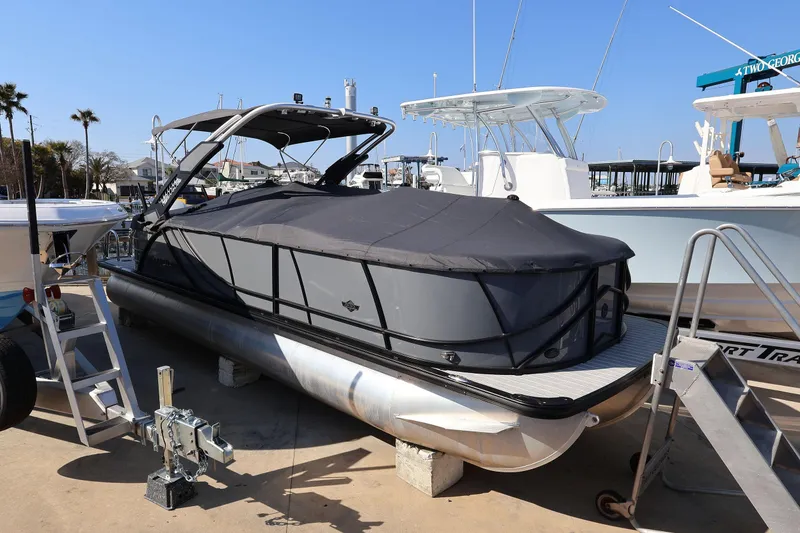 Slide: The Image of 2022 South Bay 525 RS pontoon boat covered and docked at a marina. - 20