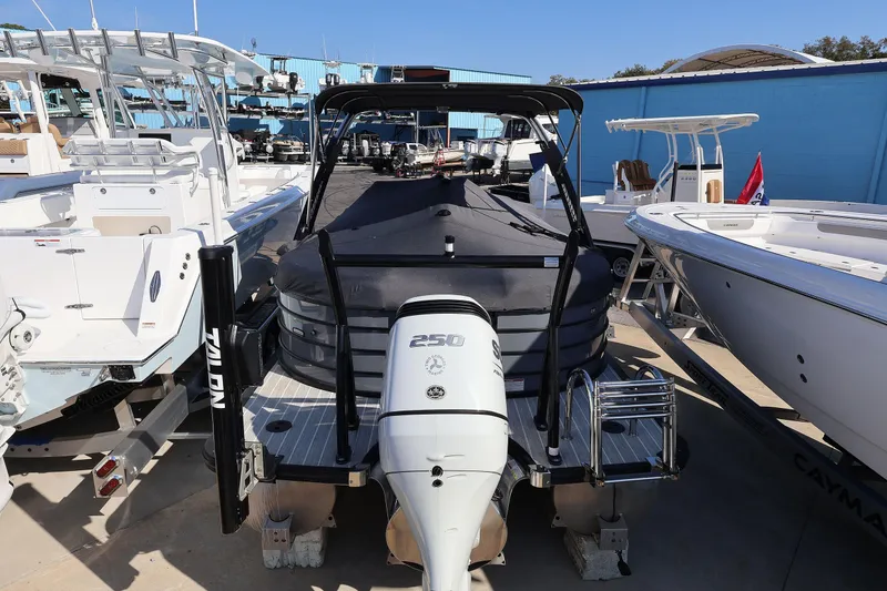 Slide: The Image of 2022 South Bay 525 RS boat with a 250 HP engine, docked among other boats. - 21