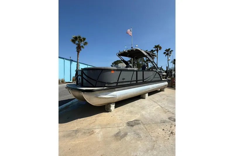 Slide: The Image of 2022 South Bay 525 RS pontoon boat on display with palm trees and clear sky. - 5