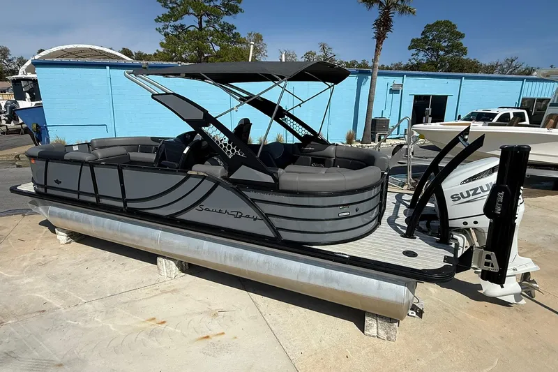 Slide: The Image of 2022 South Bay 525 RS pontoon boat with Suzuki outboard motor, docked outdoors. - 7