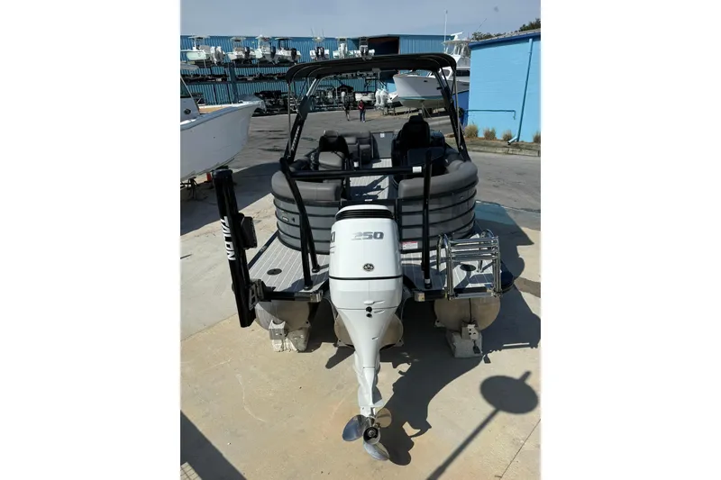 Slide: The Image of 2022 South Bay 525 RS pontoon boat with powerful outboard motor, docked at marina. - 9